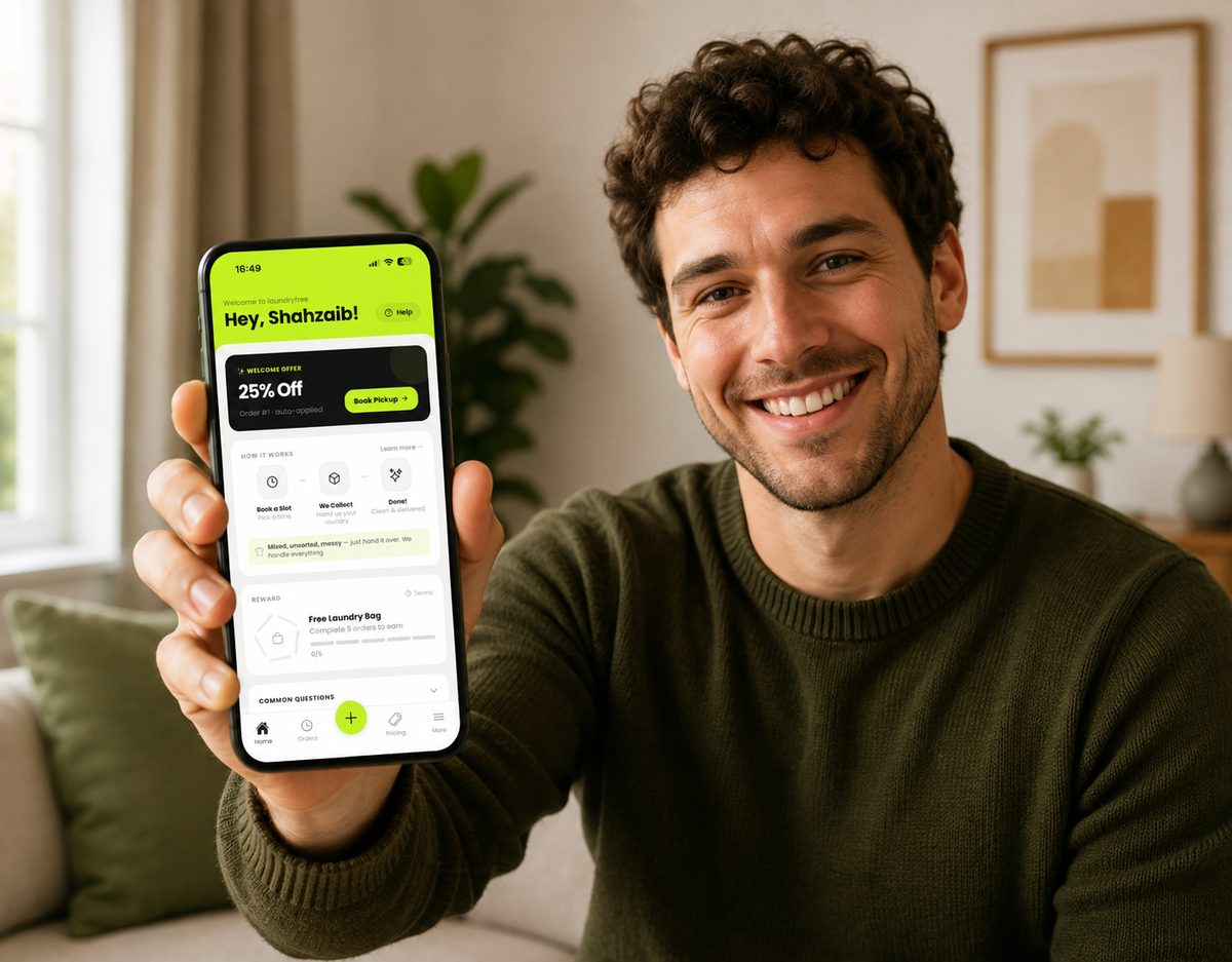 A customer holding a phone showing the LaundryFree app, with a welcome offer and the booking steps on screen.